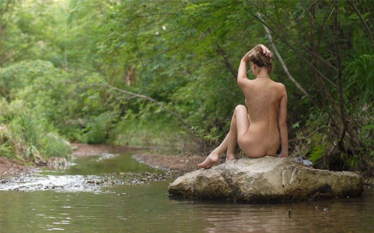 Naked women on the riverbank