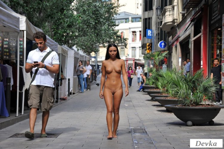 Naked woman walks along the street