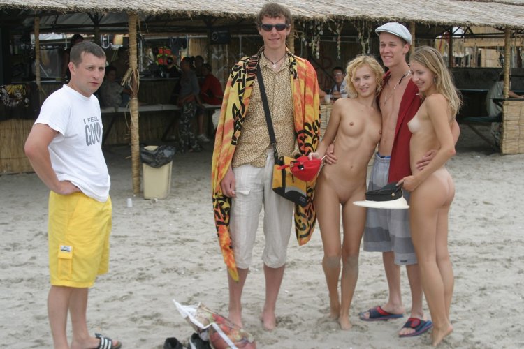 Naked on the beach among dressed