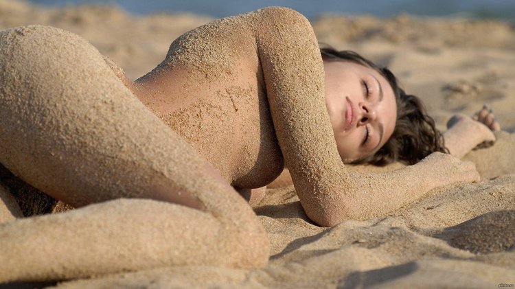 Naked girl in the sand