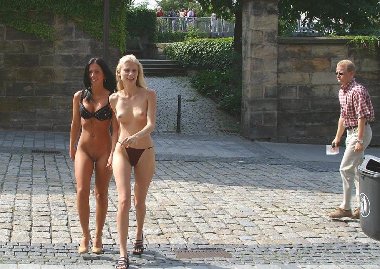 Two girls undress on the street