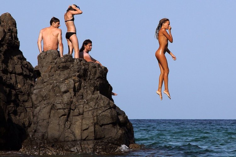 Girls jump into the water nude