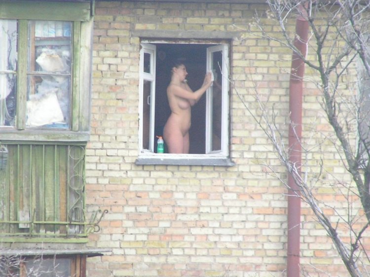 Naked women in the windows of houses