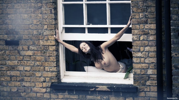 Naked women in the windows of houses