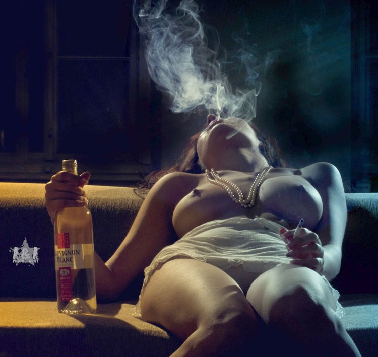 The girl smokes erotically